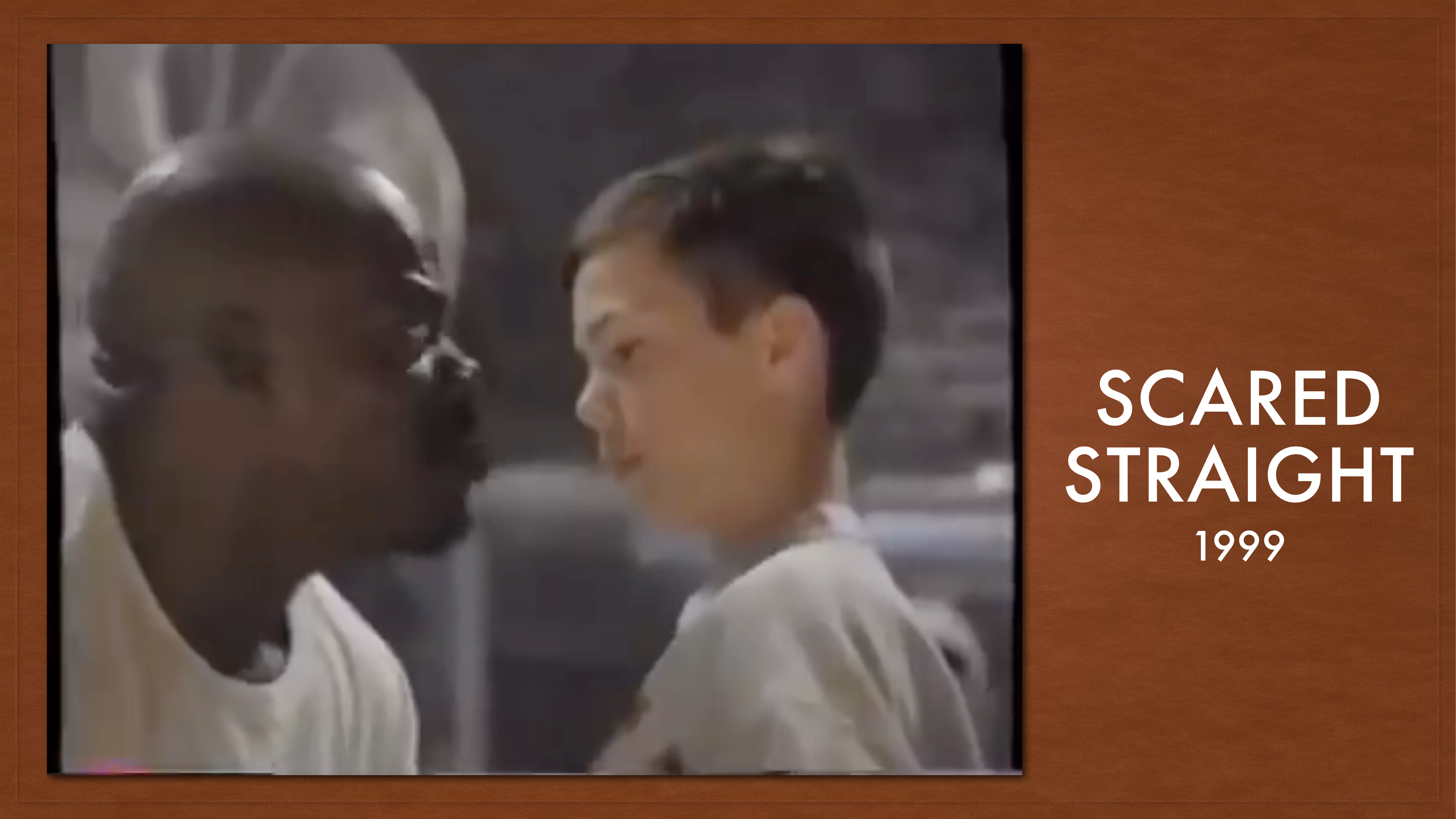 A man intensely confronts a boy indoors. The background is blurred and appears to be a brick wall. Text reads: 'SCARED STRAIGHT 1999.'